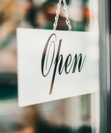 An open sign in a shop window on launch day