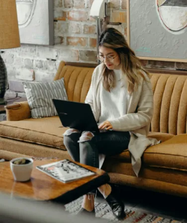 A merchant setting up her store on a laptop at home