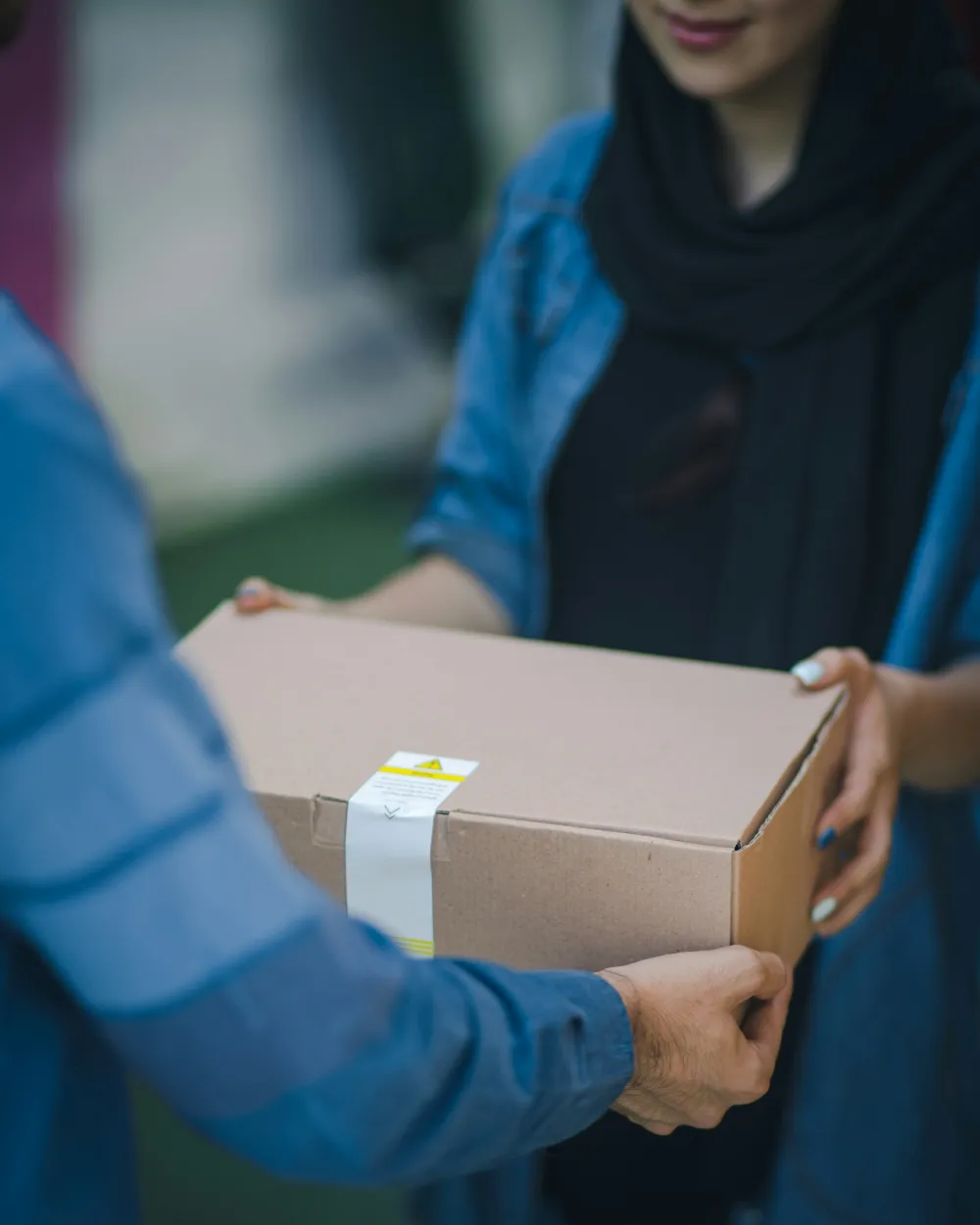 Handing a packed order to a courier
